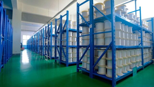 Raw material yarn stored on racks in the fishing line warehouse